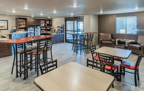 a bar with stools and tables in a restaurant at My Place Hotel-Idaho Falls, ID in Idaho Falls