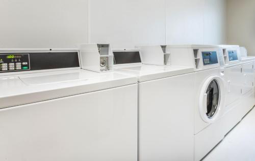 a white washing machine in a white laundry room at My Place Hotel-Idaho Falls, ID in Idaho Falls