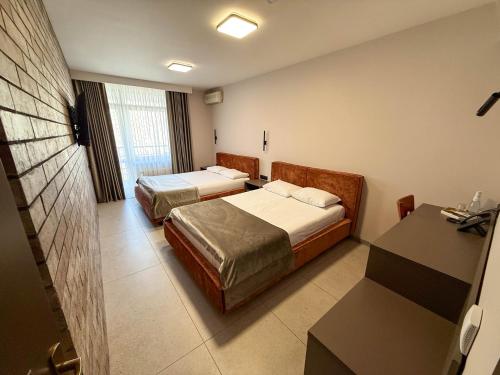 Letto o letti in una camera di Komilfo Hotel