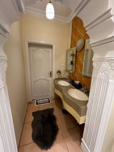 a bathroom with a sink and a mirror at Luxury studio next to Quba استديو قباء in Al Madinah