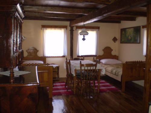 a bedroom with two beds and a table and chairs at Apartments Iža Na Trem in Čigoč