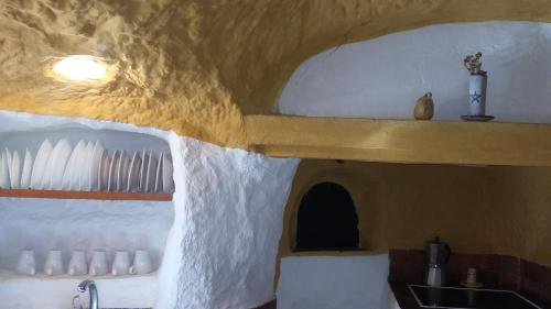 a kitchen with a concrete ceiling with a sink at Al Jatib in Baza