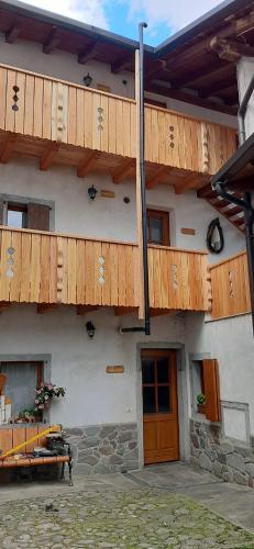 a building with wooden balconies on the side of it at Casa di Nonno Tilio in Priola