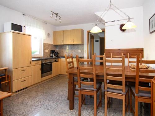 a kitchen with a wooden dining room table and chairs at Doppelhaushälfte, Zingst in Zingst