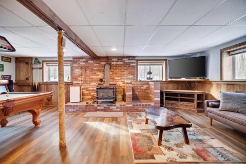 a living room with a pool table and a tv at 4 Br Cozy Cabin Sleeps 8 Pool Table Arcade Beach in Gouldsboro