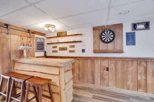 a bar in a room with a dartboard on the wall at 4 Br Cozy Cabin Sleeps 8 Pool Table Arcade Beach in Gouldsboro
