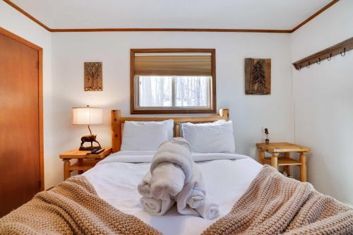 a stuffed elephant sitting on top of a bed at 4 Br Cozy Cabin Sleeps 8 Pool Table Arcade Beach in Gouldsboro