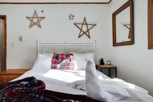 a bedroom with a bed with christmas decorations on it at 4 Br Cozy Cabin Sleeps 8 Pool Table Arcade Beach in Gouldsboro
