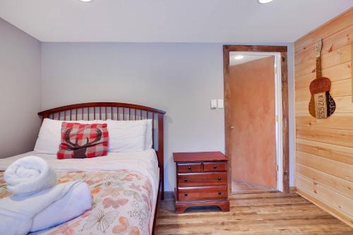 a bedroom with a bed and a dresser and a door at 4 Br Cozy Cabin Sleeps 8 Pool Table Arcade Beach in Gouldsboro