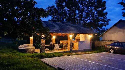 a house with a patio at night with lights at Apartmán Šumiac 6 in Šumiac