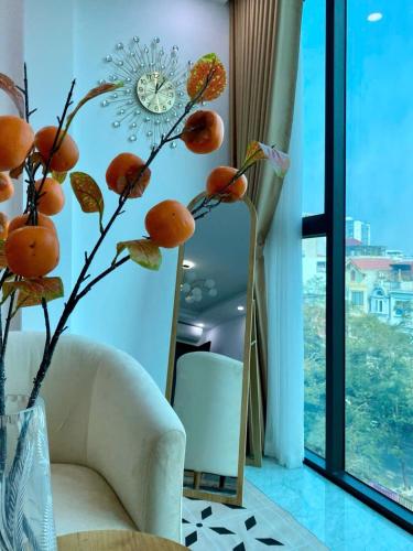 a living room with a white couch and a window at The Grand Diamond C Tuong Mai in Hanoi
