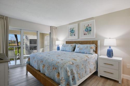a bedroom with a bed with a blue vase on it at Stunning Beachfront Residence at The Sanibel Inn- Resort Amenities Included! in Sanibel