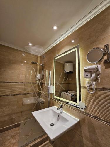 a bathroom with a sink and a mirror at Sheraton Ocean 103 - Without Pool access in Cairo