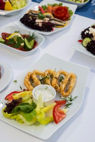 a white table with plates of food on it at Palm World Side Resort & Spa in Side