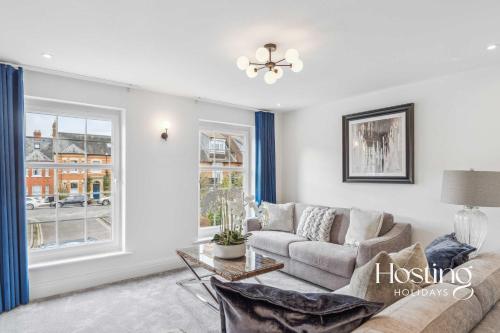 a living room with a couch and a window at Queens Mews Brand New Luxury Home with Parking in Henley on Thames