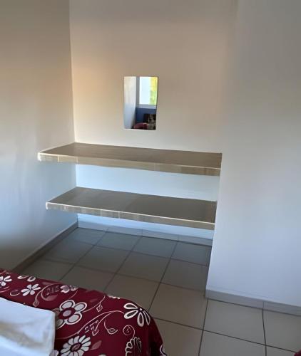 a room with a shelf with a mirror on the wall at C4 Alberca privada a 5 min de la playa planta alta in Peñita de Jaltemba