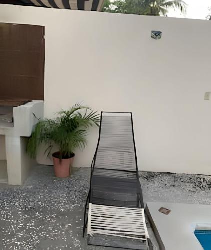 a metal bench sitting on top of a patio at C12 · Casa 2 niveles, alberca y vista al manglar in Peñita de Jaltemba
