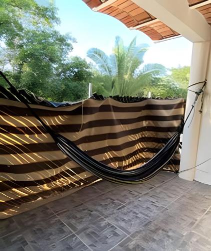 a hammock in a room with a window at C4 Alberca privada a 5 min de la playa planta alta in Peñita de Jaltemba