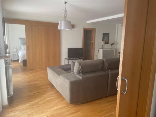 a living room with a couch and a bedroom at El Rincón del Ángel in Jaca