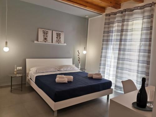 a bedroom with a bed with two towels on it at CasAnna in Castellammare del Golfo