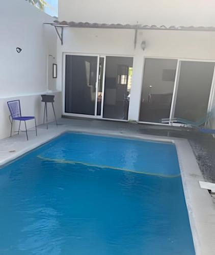 a large blue swimming pool in a house at C9 Casas la colmena a 3 min playa alberca 2 rec. in Peñita de Jaltemba