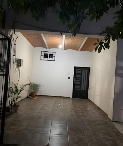 a room with a white wall and a black door at C7 Casas la colmena a 3 min playa alberca 4 rec, in Peñita de Jaltemba