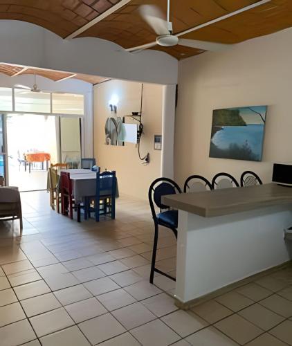 a dining room with a table and chairs at C1 Alberca privada a 5 min de la playa y manglar! in La Peñita de Jaltemba