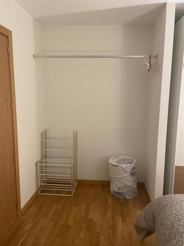 a bedroom with a bed and a metal shelf at El Rincón del Ángel in Jaca