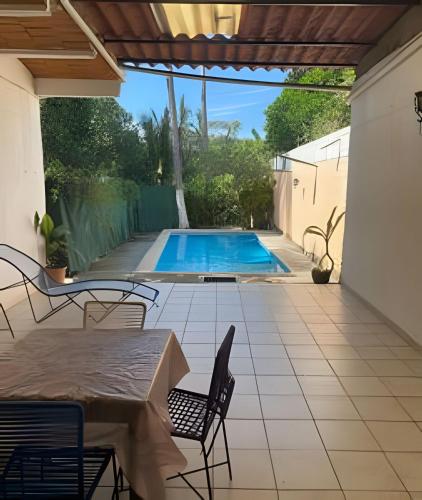 a patio with a table and chairs and a swimming pool at C1 Alberca privada a 5 min de la playa y manglar! in La Peñita de Jaltemba
