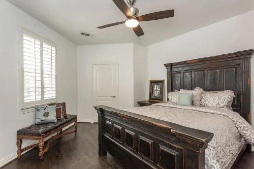 a bedroom with a large bed and a ceiling fan at Lakeside Grand Villa - Lone Star State Little Elm in Little Elm