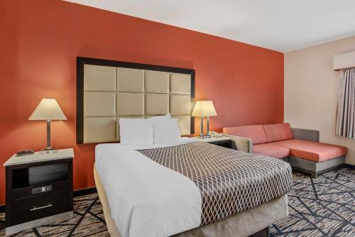 a hotel room with a bed and a couch at Best Western Carlisle in Carlisle