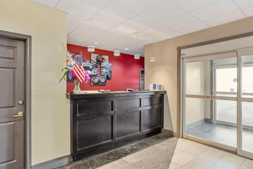 a room with a bar with a red wall at Best Western Carlisle in Carlisle