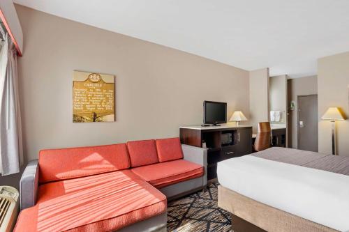 a hotel room with a bed and a couch at Best Western Carlisle in Carlisle
