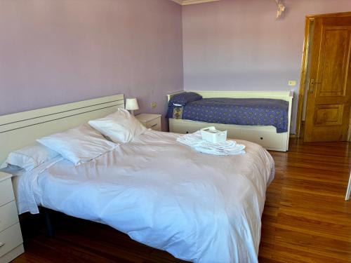 a bedroom with a white bed with a tray on it at CASA MENCIA in Sober