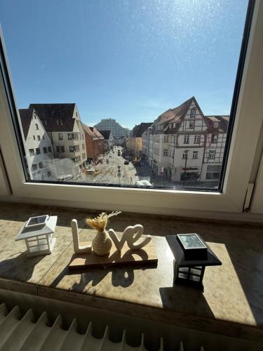 a large window with a view of a city at City Appartement in Ulm Old City-Center in Ulm