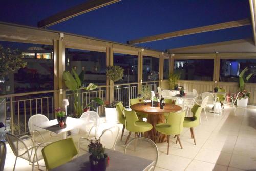 a restaurant with tables and chairs on a balcony at Urban Frame Acropolis in Athens