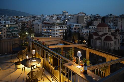 a balcony with a view of a city at night at Urban Frame Acropolis in Athens
