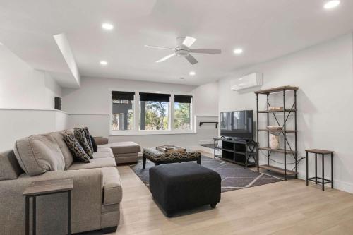 a living room with a couch and a tv at Modern Wellfleet Retreat with Stunning Outdoor Spaces in Wellfleet