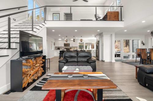 a living room with a couch and a table at Modern Wellfleet Retreat with Stunning Outdoor Spaces in Wellfleet