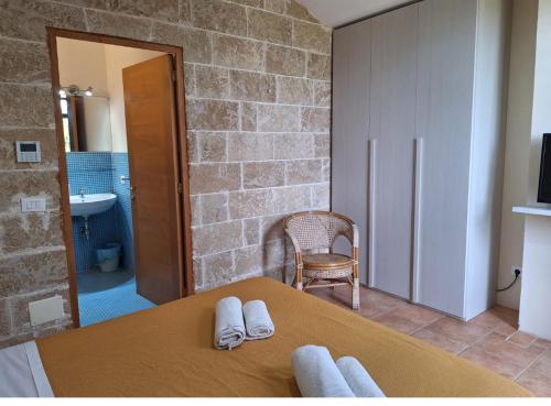 a bedroom with a bed with towels on it at Masseria Le Celline in Nardò