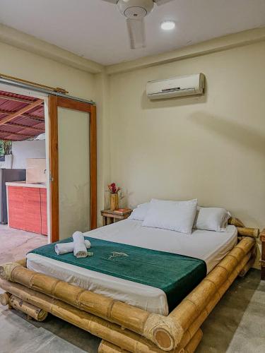 a bedroom with a large bed in a room at Tayrona Cachaco River Ecohostal in El Zaino
