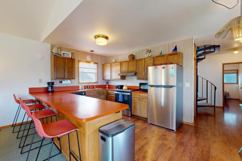 a kitchen with a wooden counter and a refrigerator at Bridge to the Beach in Neskowin