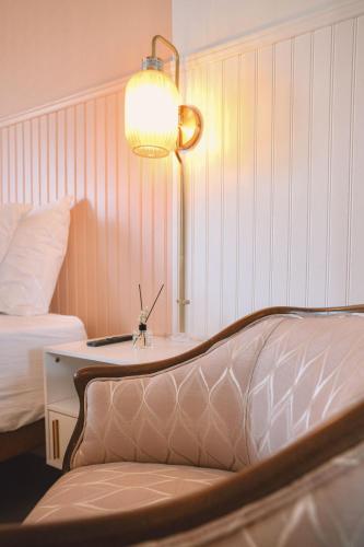 a bedroom with a bed and a table with a lamp at Peninsula Bed & Cocktails in St Petersburg