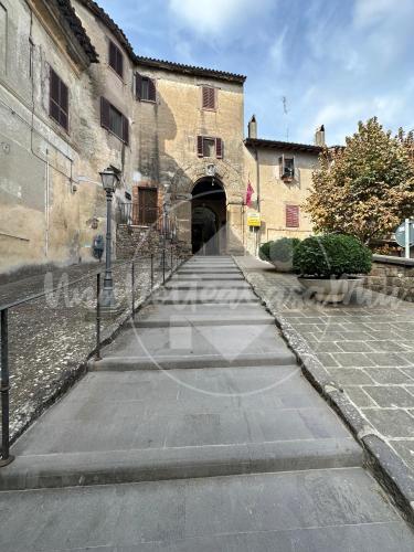 an alley way in an old building with a tunnel at La Scalinatella "UnaNotteaCasaMia" in Sacrofano