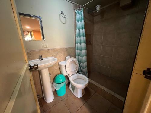 a small bathroom with a toilet and a sink at La Querencia in Cuenca