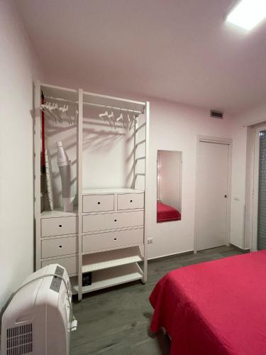 a white bedroom with a bed and a dresser at Casa Macallè - Letojanni - Taormina in Letojanni