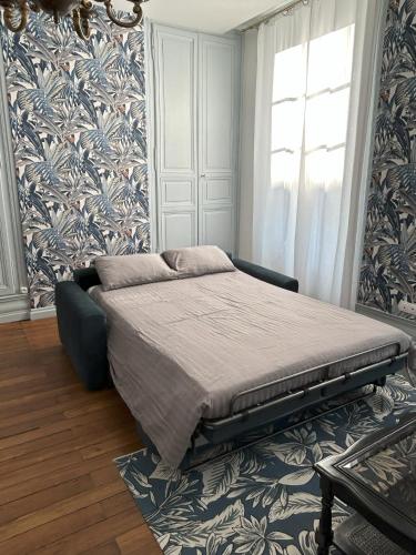 En eller flere senge i et værelse på Appartement centre ville