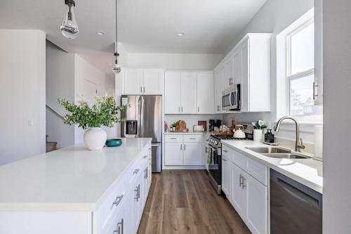 a white kitchen with white cabinets and white counter tops at The Copperleaf Flagstaff Escape in Flagstaff