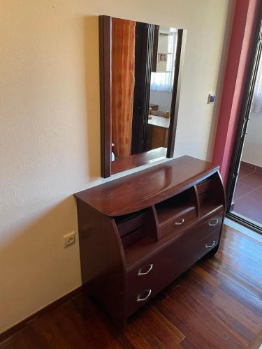 a bathroom with a wooden dresser with a mirror at Grand Luxury Apartment Seafront Kalamata in Kalamata