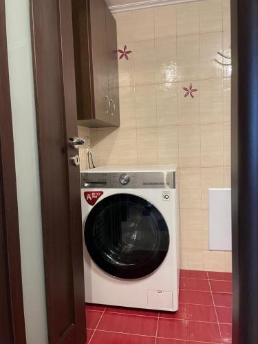 a kitchen with a washing machine in a kitchen at Grand Luxury Apartment Seafront Kalamata in Kalamata
